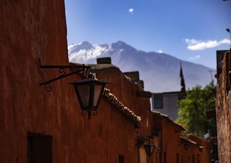 Views of the Misti volcano from the narrow streets with red walls of the Saint Catherine Monastery (Convento de Santa Catalina), Arequipa city, Peruの写真素材