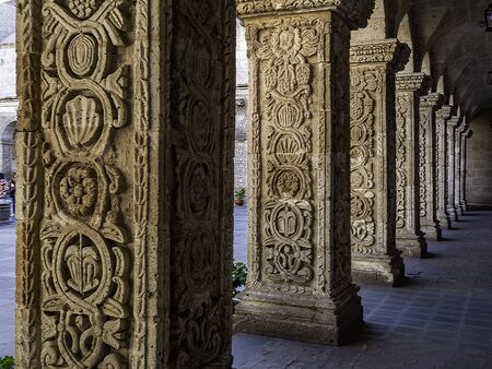 Close view to decorated details in the cloister of a church. Carved columns of Church of The...