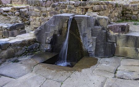 A fountain ruins carved in stone called the bath of the princess, Ollantaytambo Archaeological Park, Peruの写真素材