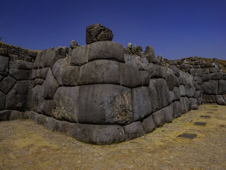 Huge block of carved stone forms the rounded and perfectly polished corner of the Sacsayhuaman wall