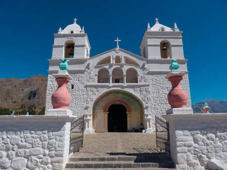 Frontal view of a white facade in Church of Santa Ana in Maca, Colca Valley, Arequipa region, Peru
