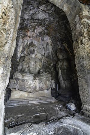 Buddha statue carved in a cave. Figure in Wei style grotto at Longmen Grottoes, Henan province, Chinaの写真素材