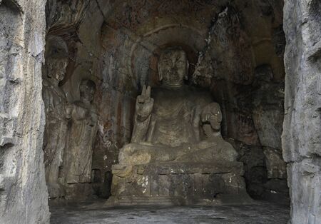 Buddha statue carved inside a cave. Early Northern Wei style grotto at Longmen Grottoes, Henan province, Chinaの写真素材