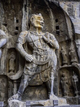 Statue of Vajrapani in the main cave (Fengxiangsi Cave) of Longmen Grottoes in Luoyang,. A major Buddhist caves of Chinaの写真素材