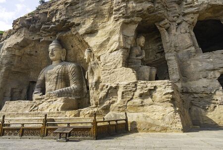 Bid buddha statues carved directly on a mountain hill. Yungang Grottoes in Datong, Shanxi Province, Chinaの写真素材