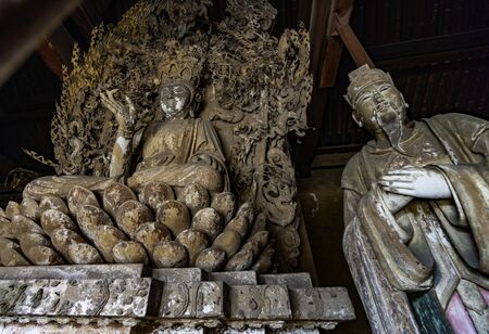 Old statue of buddha and chinese god in ancient altar with carved details carved in wood. Altar figure located in Shuanglin Temple (or Zhongdu Temple), outskirts Pingyao Old City, Shanxi province, Chinaの写真素材