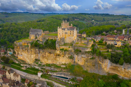 Aerial landscape. Ancient medieval Castle of Beynac stands on a top of a hill over the Dordogne river. Beynac et Cazenac is a village labeled Most beautiful villages of France.のeditorial素材