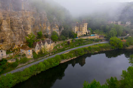 France, the picturesque village of La Roque Gageac in Dordogne covered by fog and low clouds. Dordogne river. Perigord zone, Nouvelle-Aquitaine, southwestern France.のeditorial素材