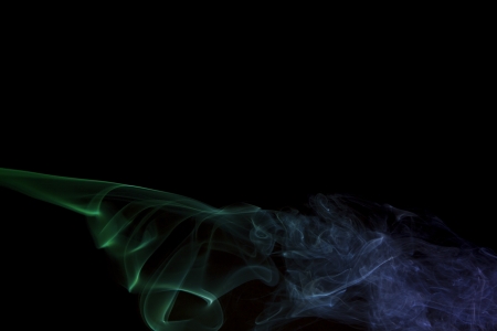 Colored Smoke on black backgroundの写真素材