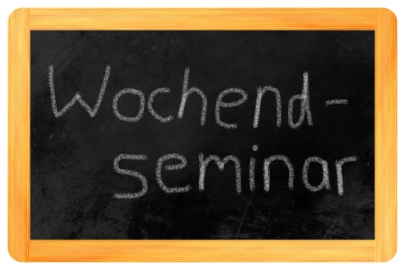 Wochenendseminar  german weekend seminar  written on a blackboardの写真素材