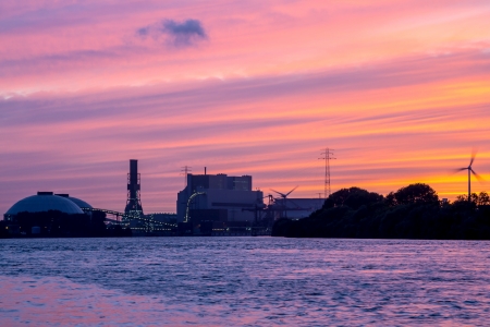 A Power Plant near a river during sunsetの写真素材