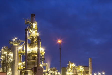 An illuminated chemical plant during twilight hourの写真素材