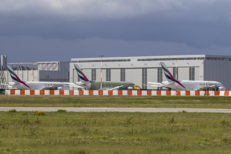 HAMBURG, GERMANY - SEPTEMBER 16, 2013: Lineup of three Emirates Airbus A380 in different development stages on the Airbus Plant in Hamburg Finkenwerder on SEPTEMBER 16, 2013. のeditorial素材