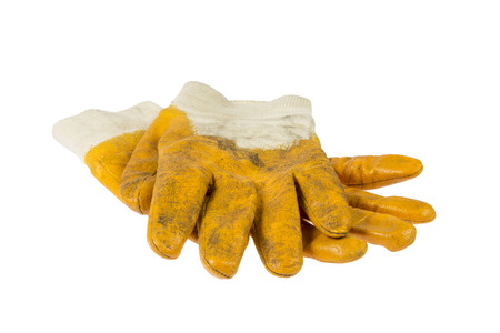 Used yellow working gloves isolated on white の写真素材