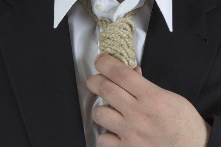 Businessman wearing a hangman's noose instead of a tie around the neckの写真素材