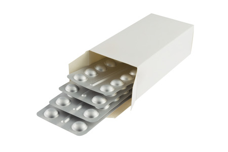 Blister with pills in a white package isolated on white の写真素材