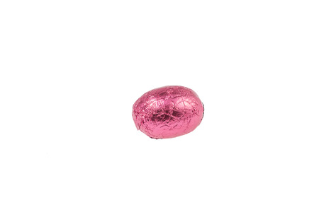 chocolate easter egg wrapped in aluminum foil isolated on white backgroundの写真素材