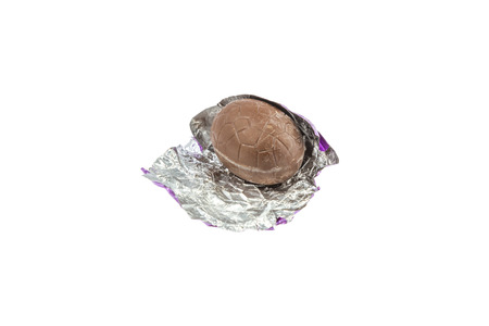 unwrapped chocolate easter egg isolated on white backgroundの写真素材
