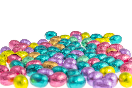 chocolate easter eggs wrapped in colorful aluminum foil isolated on white backgroundの写真素材