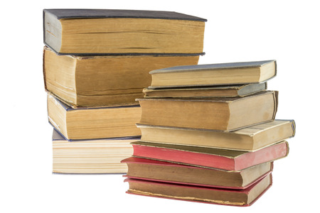 Two stacks of old books isolated on white backgroundの写真素材
