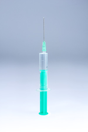 single use syringe on white gray backgroundの写真素材