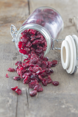 Dried Cranberries in a Jar on a wooden tableの写真素材