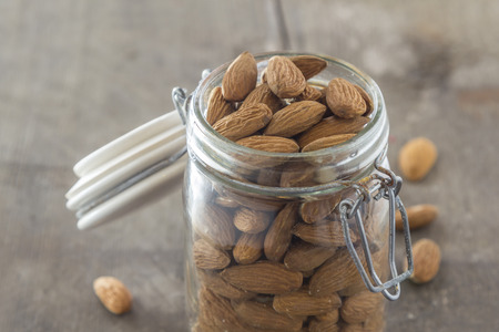 almonds in a jar on a wooden tableの写真素材