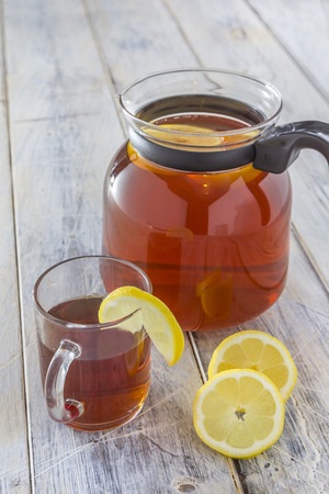 Can of fresh brewed ice tea with lemon on a white tableの写真素材