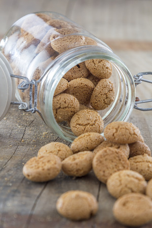 Traditional italian amarettini cookies in a jar on a wooden tableの写真素材