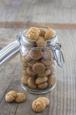 Traditional italian amarettini cookies in a jar on a wooden tableの写真素材