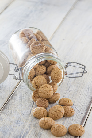 Traditional italian amarettini cookies in a jar on a wooden tableの写真素材