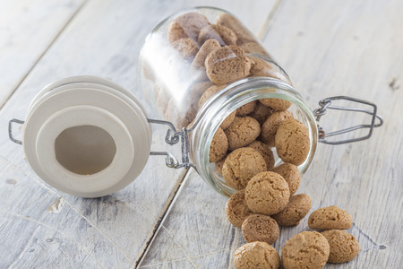 Traditional italian amarettini cookies in a jar on a wooden tableの写真素材