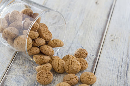 Traditional italian amarettini cookies in a glass on a wooden tableの写真素材
