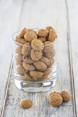 Traditional italian amarettini cookies in a glass on a wooden tableの写真素材
