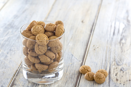 Traditional italian amarettini cookies in a glass on a wooden tableの写真素材