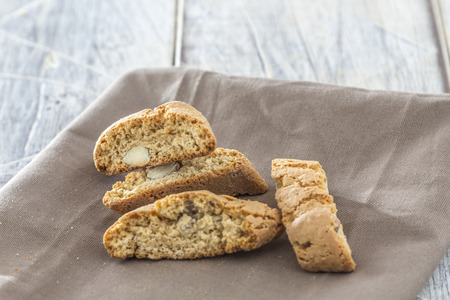 Traditional italian biscotti cookies on a brown napkin on a wooden tableの写真素材