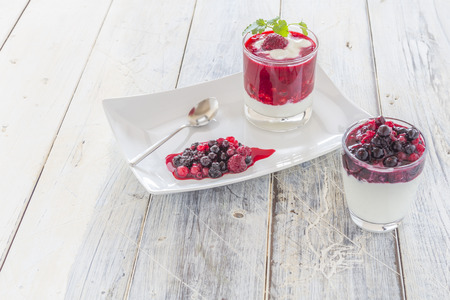 Raspberry Cream in a glass on a wooden tableの写真素材