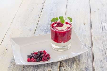 Raspberry Cream in a glass on a wooden tableの写真素材