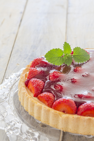Homemade strawberry cake on a wooden tableの写真素材
