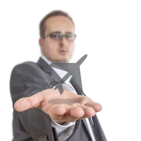 Business man reaches out his arm with an aircraft symbol floating over his hand. Isolated on White Backgroundの写真素材
