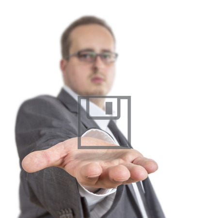 Business man reaches out his arm with a Disk symbol floating over his hand. Isolated on White Backgroundの写真素材