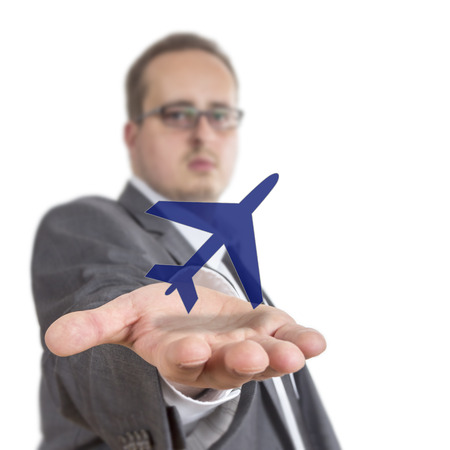 Business man reaches out his arm with an aircraft symbol floating over his hand. Isolated on White Backgroundの写真素材