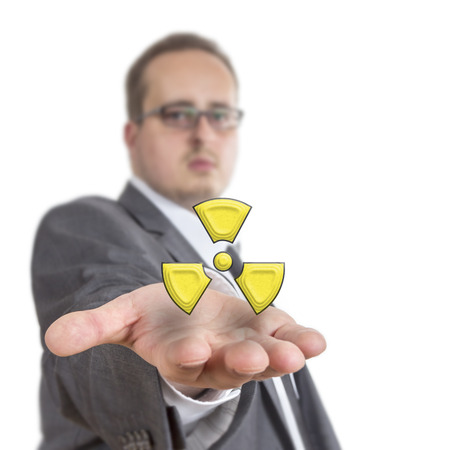 Business man reaches out his arm with a radioactive symbol floating over his hand. Isolated on White Backgroundの写真素材