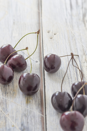 Fresh cherries on a rustic wooden tableの写真素材