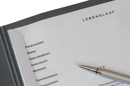 Lebenslauf (german curriculum vitae) in a job application binder and a silver pen isolated on white backgroundの写真素材