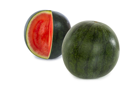 A complete watermelon and one with with one slice missing isolated on white backgroundの写真素材