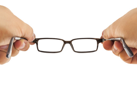 Modern retro lookin glasses beeing hold by two hands isolated on white backgroundの写真素材