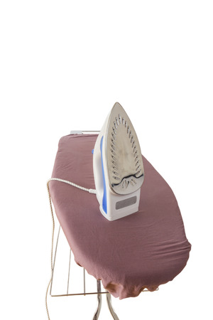 A steam iron on an ironing board isolated on white backgroundの写真素材