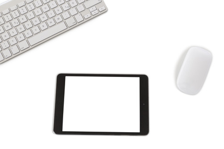 A modern keyboard, a mouse and a tablet computer with white clipped screen isolated on white backgroundの写真素材