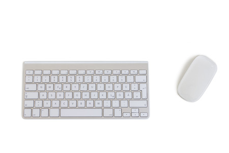 A modern wirekess keyboard and a mouse isolated on white backgroundの写真素材